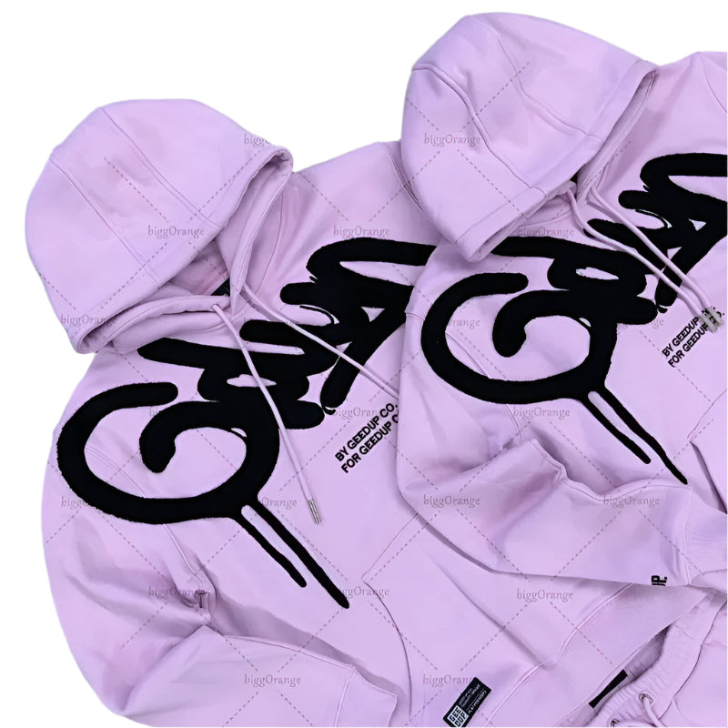 Purple hoodie with black logo on a gray surface