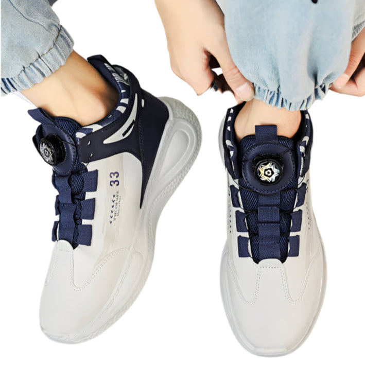 Person wearing navy and white sneakers with a floral design on a dark surface