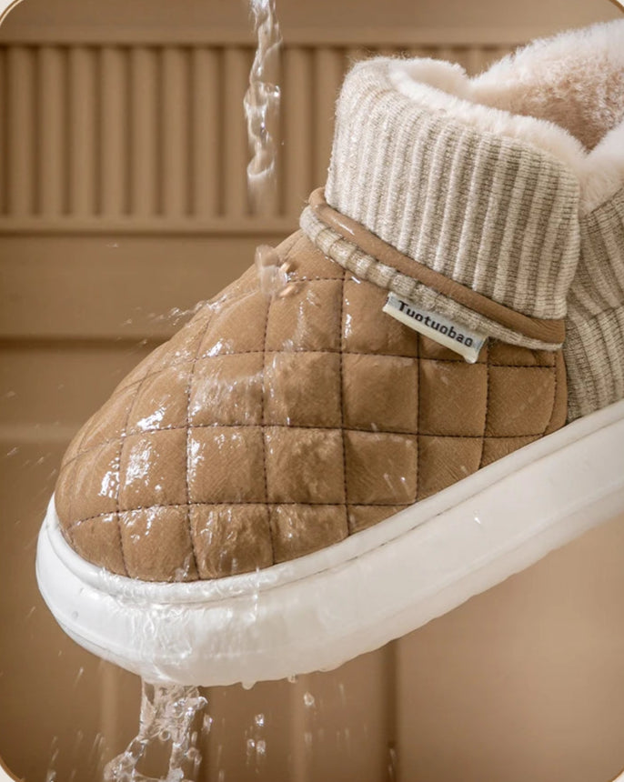 Brown quilted boot with white sole being washed, featuring waterproof text and branding.