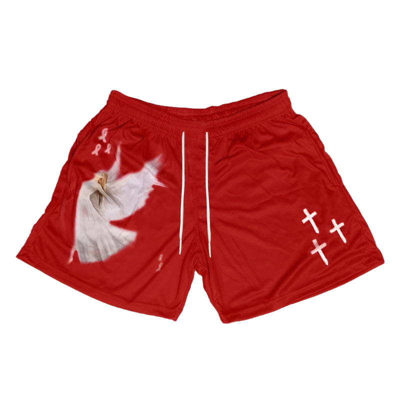 Red shorts with a graphic design on a gray concrete surface