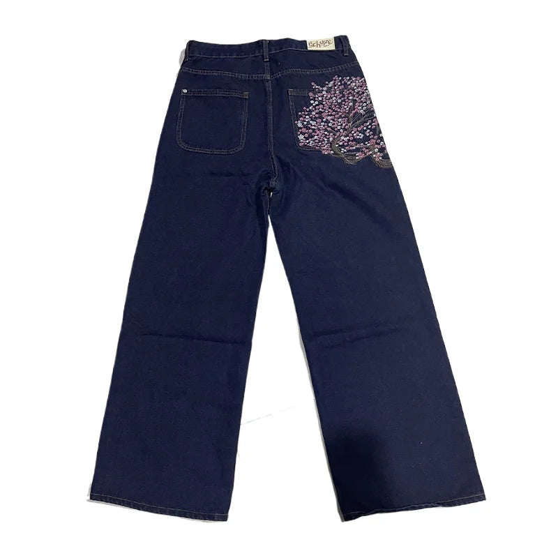 Navy blue jeans with decorative pocket on a white background