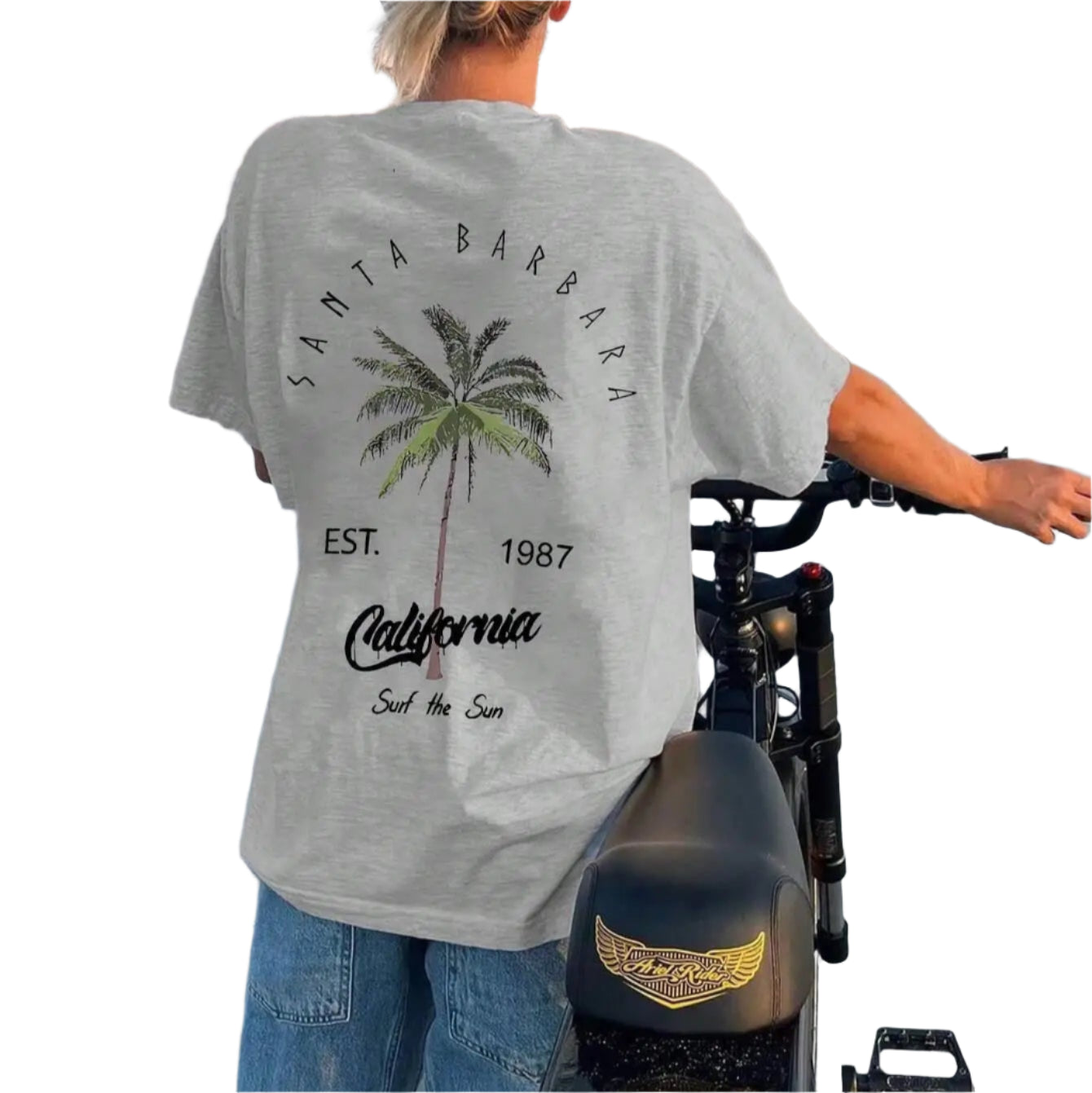Person wearing a Santa Barbara t-shirt on a beach with palm tree design