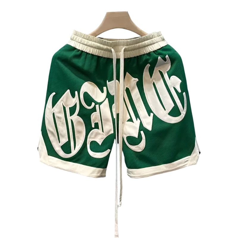 Green shorts with white text on a hanger against a light blue background