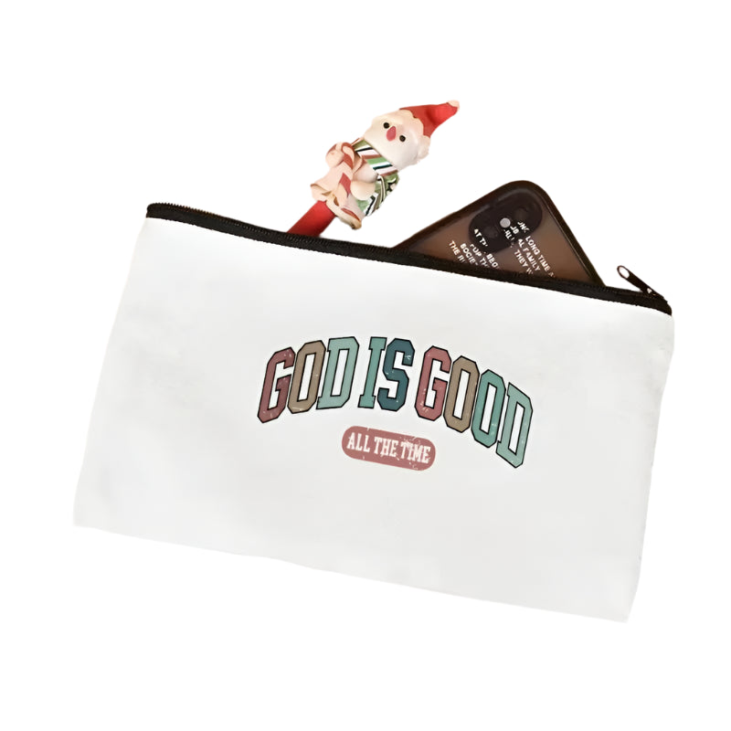 White pouch with 'GOD IS GOOD ALL THE TIME' text on a light pink surface.