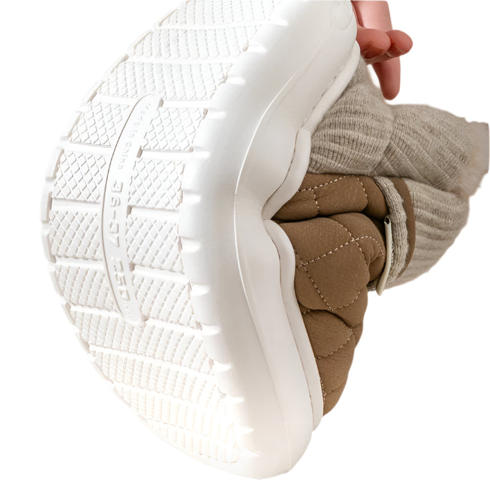 White sole of a shoe held by a hand, with text about a resilient sole.