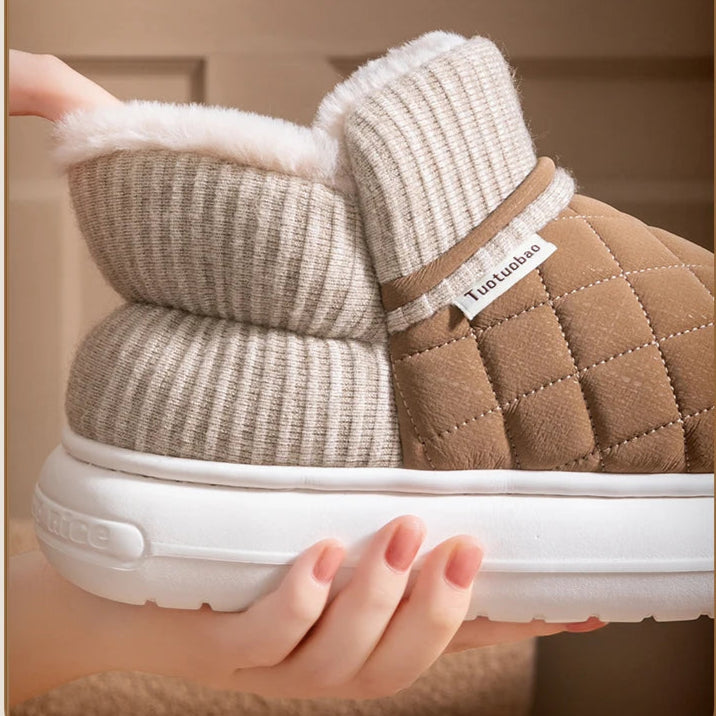 Brown winter boot with white sole and elastic heel on a beige background