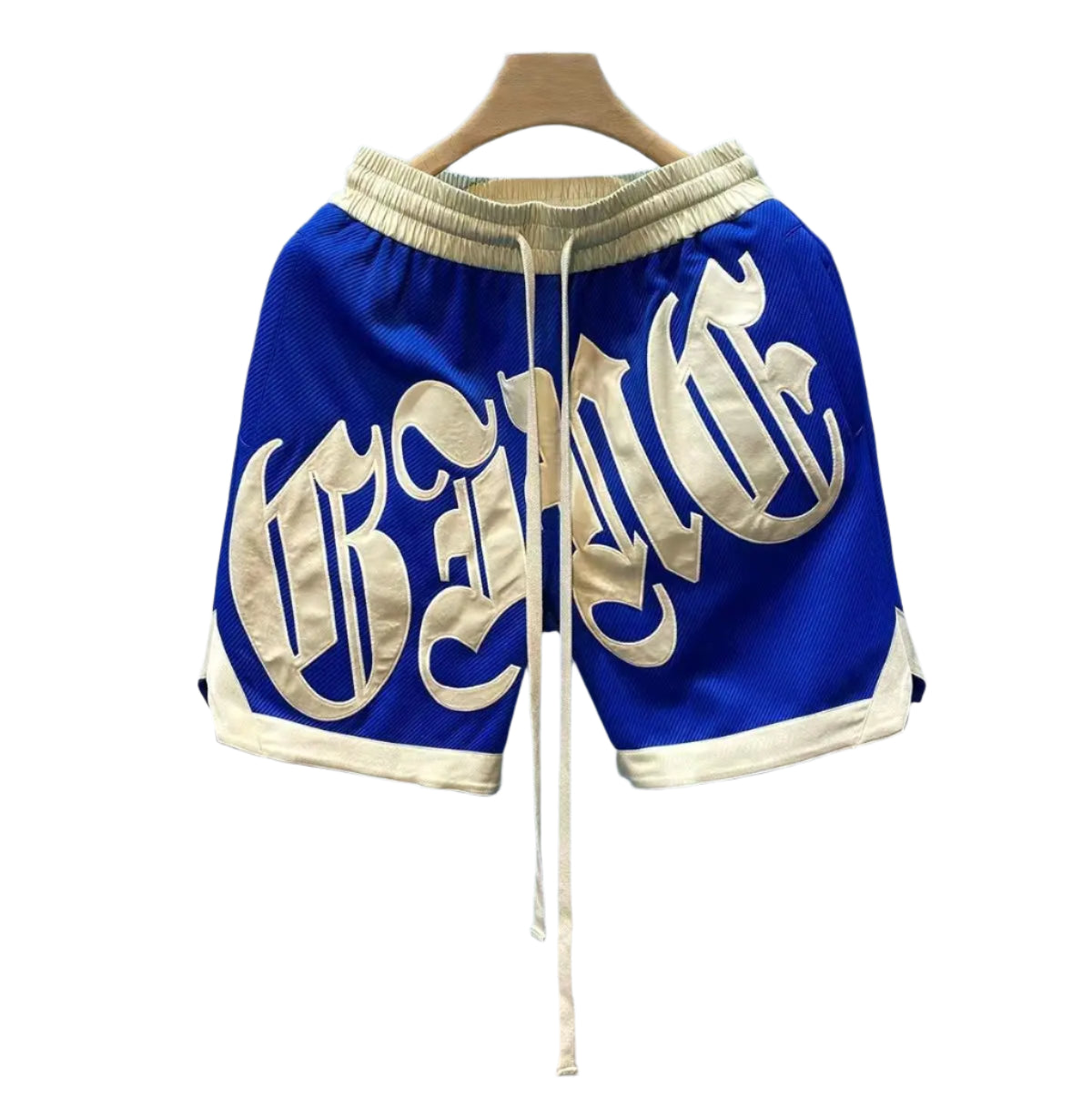 Blue shorts with gold lettering on a hanger against a light blue background