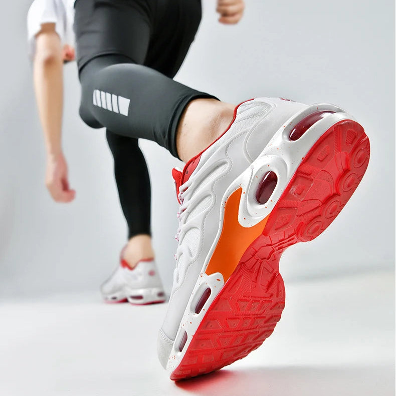 Person wearing a white and red sneaker with a gray background