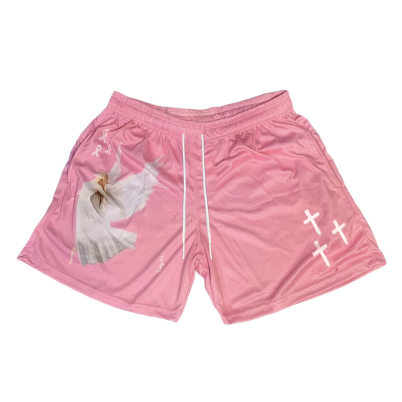 Pink shorts with white designs on a gray concrete surface
