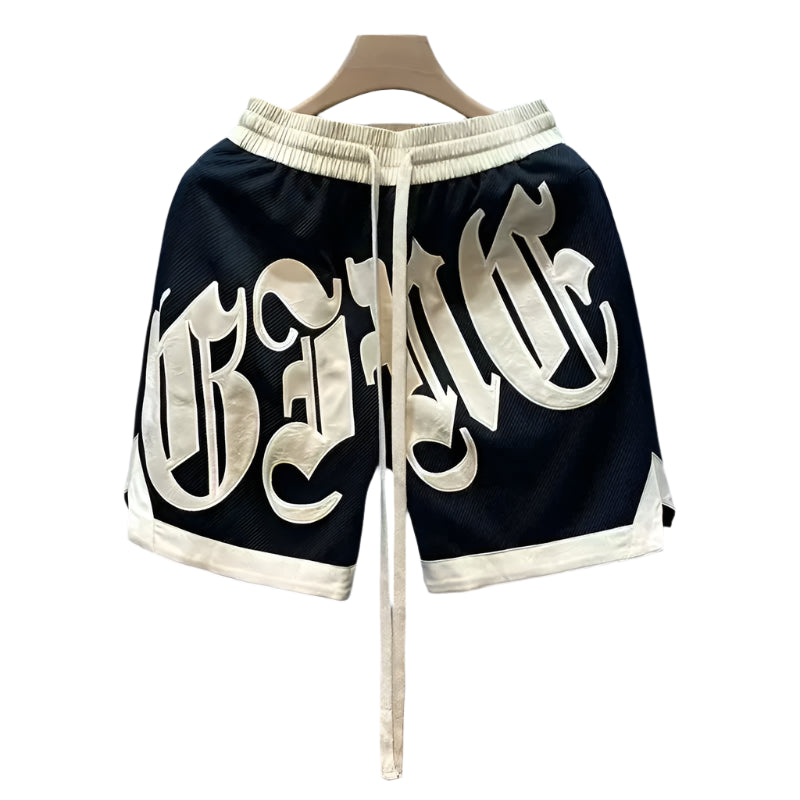 Black shorts with white lettering on a hanger against a light blue background