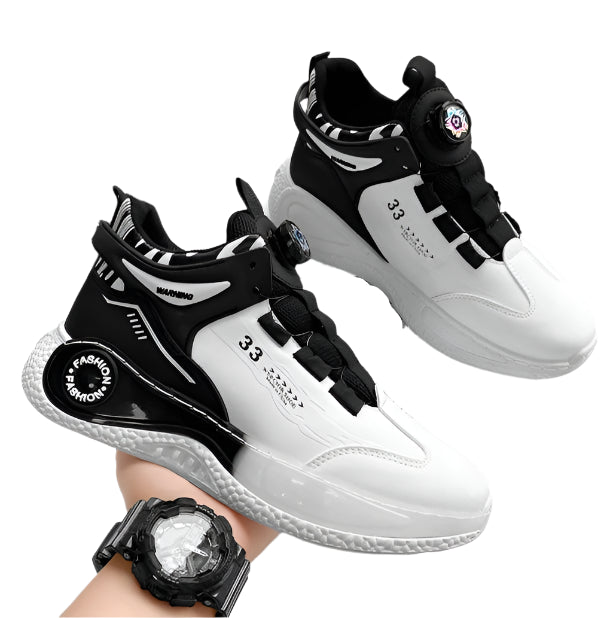 Black and white sneakers with '33' branding on a laptop and desk.