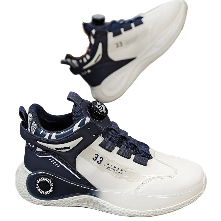 White and navy children's sneakers with a visible brand logo on a neutral background