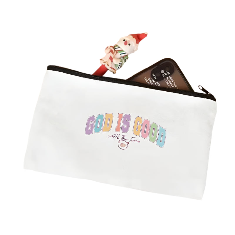 White pouch with 'GOD IS GOOD All The Time' text on a light pink surface.