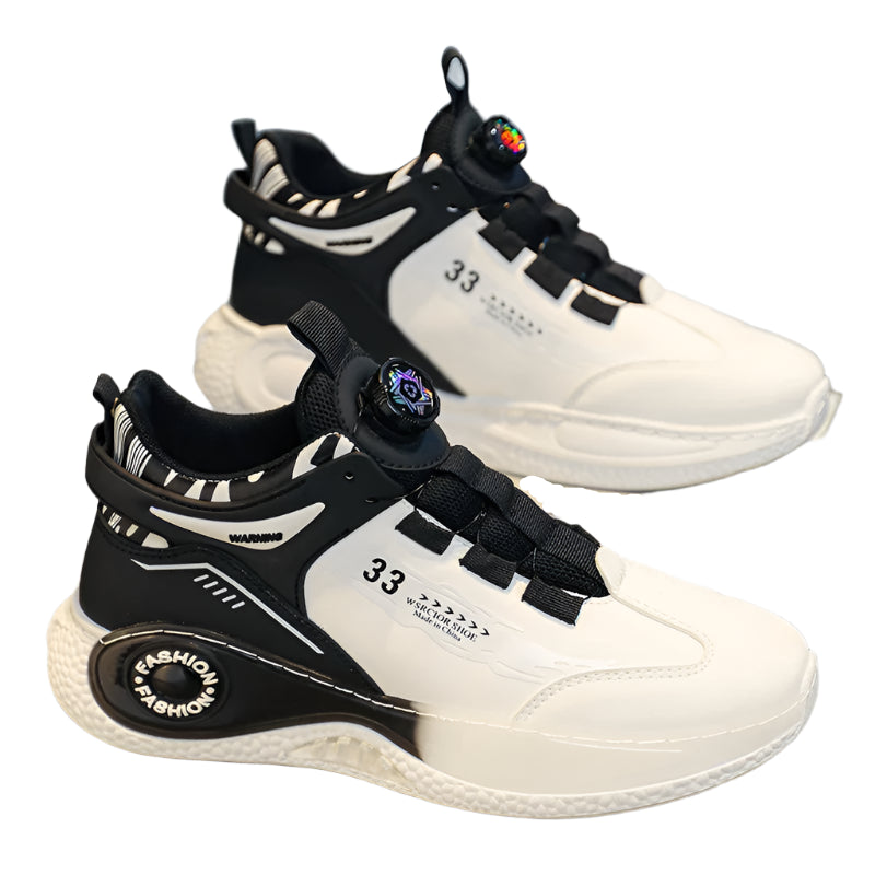 White and black sneakers with unique design elements on a gray surface