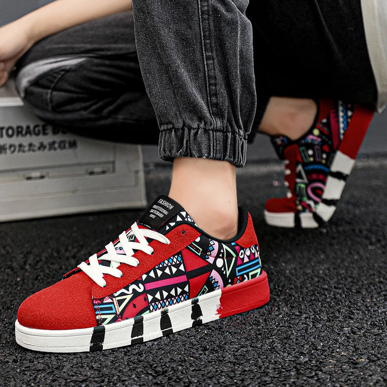 Person wearing red patterned sneakers with black pants and colorful socks.