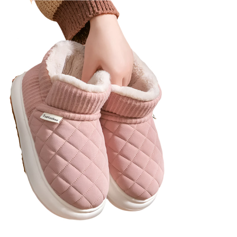 Pink quilted slippers with white sole on a pink background, featuring text 'keep warm Cold proof'.