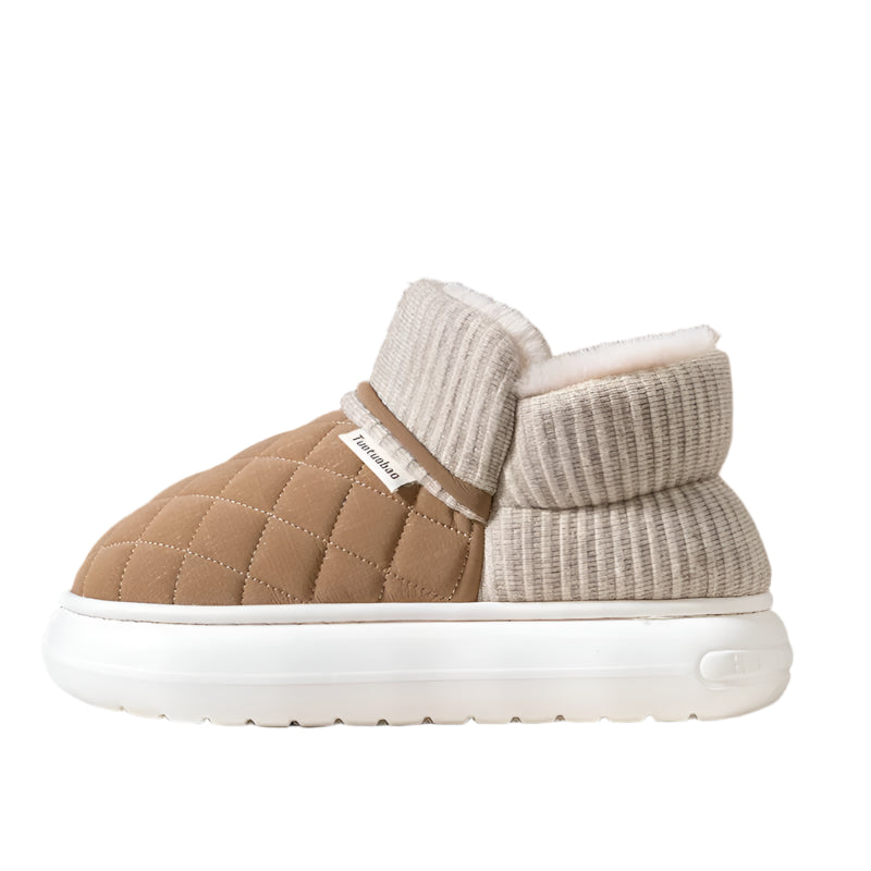 Brown and beige quilted slippers with white sole on a neutral background