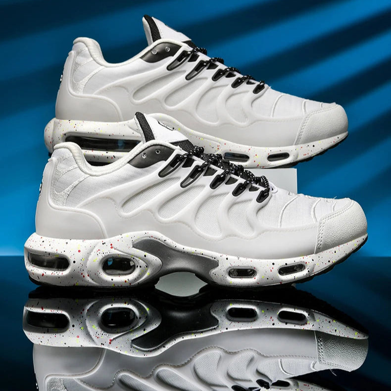 White sneakers with black accents on a blue and gray gradient background