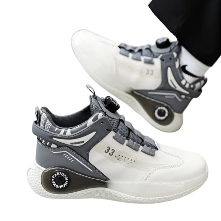 White and gray sneakers with unique design elements on a light gray floor.