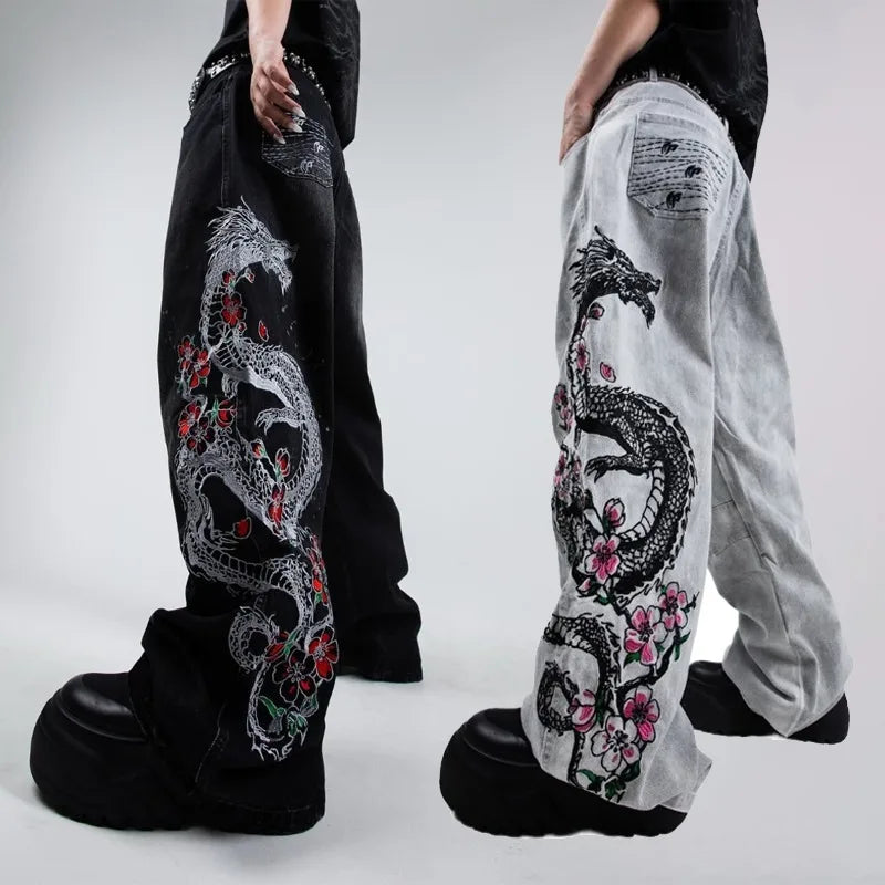 Black and white pants with dragon and floral designs on a plain background