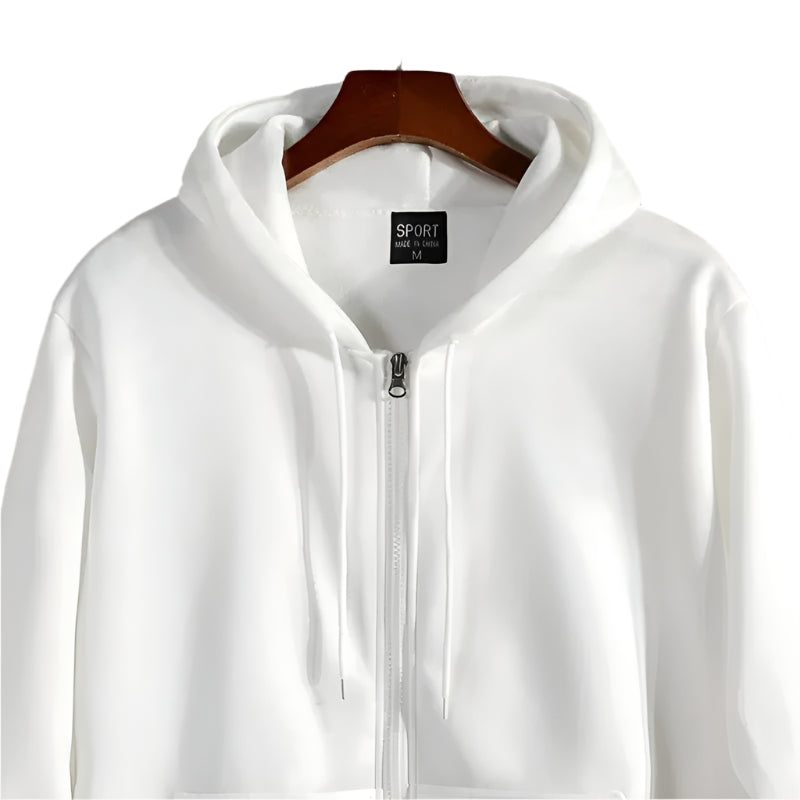 White hoodie with a brand label on a wooden hanger against a stone wall background