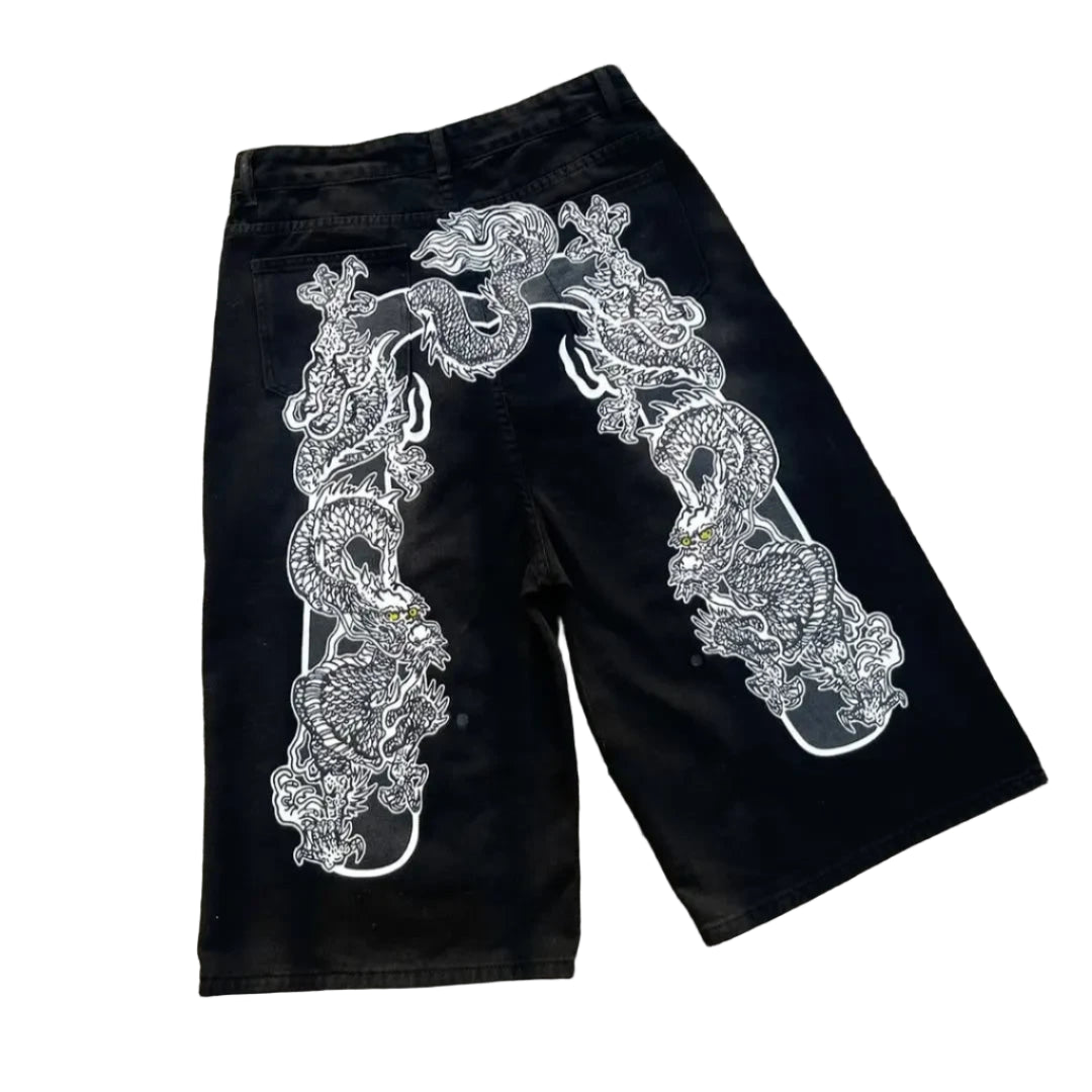 Black shorts with white intricate design on a concrete surface