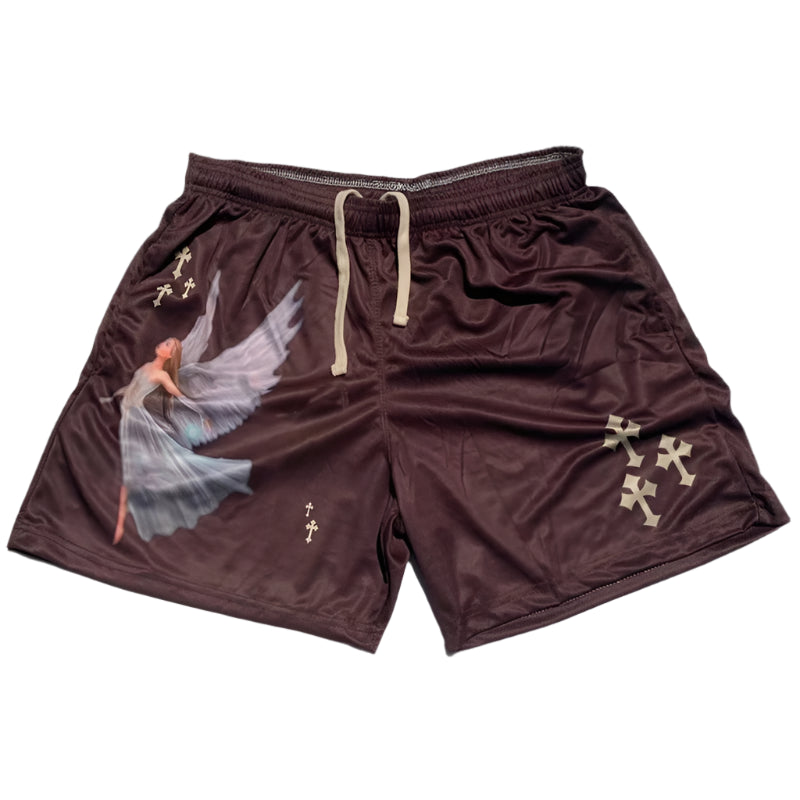 Brown shorts with angel design and cross patterns on a gray surface