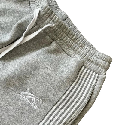 Gray sweatpants with a brand logo on a wooden surface