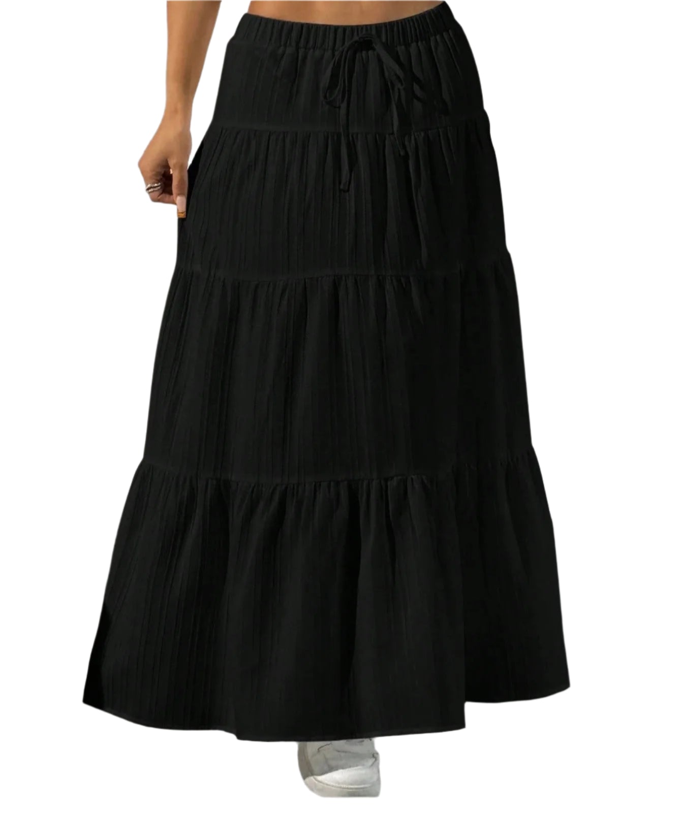 Black tiered skirt worn by a person on a plain background