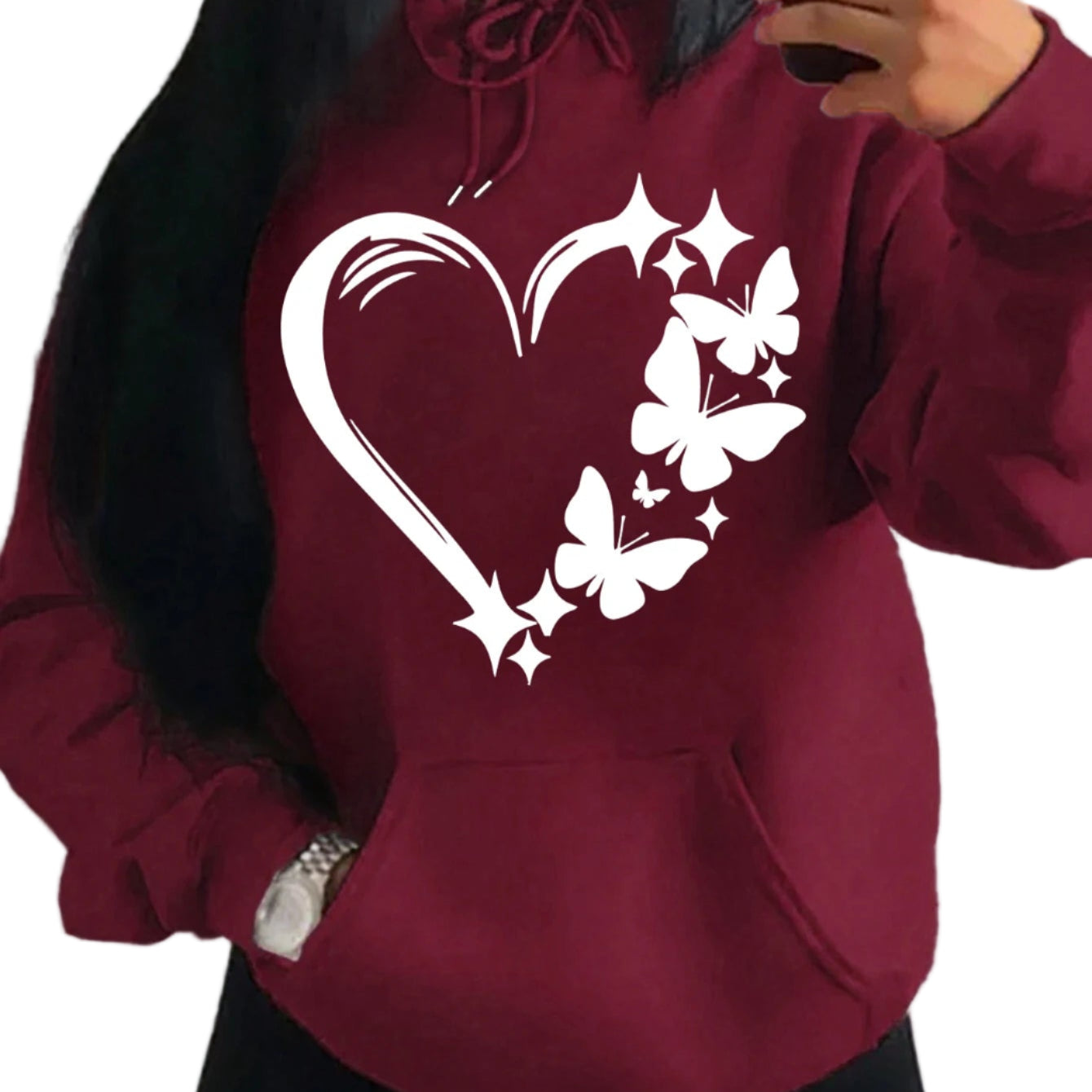 Maroon hoodie with a heart and butterfly design worn by a person.