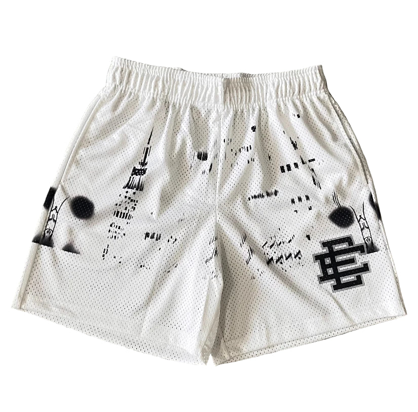 White shorts with black patterns and designs on a gray surface