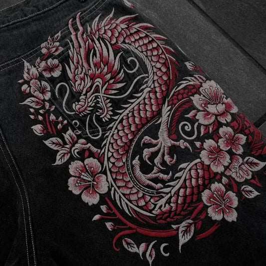 Embroidered dragon design on a black fabric background