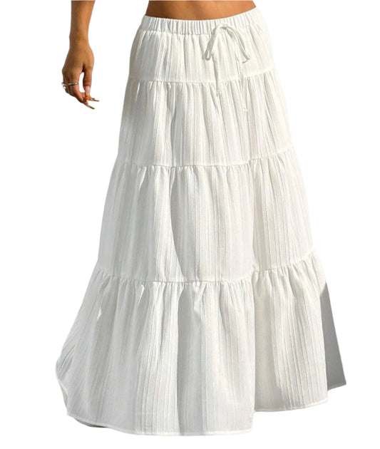 White tiered skirt worn by a person on a plain background