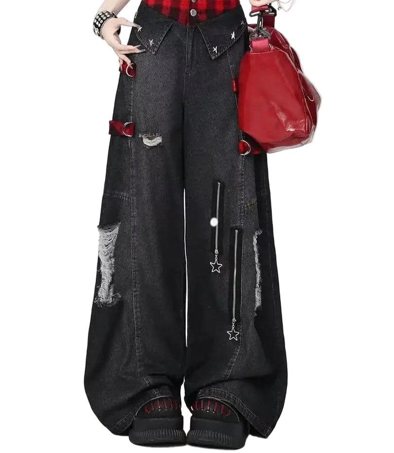 Person wearing black distressed jeans with red plaid shirt and red bag on white background