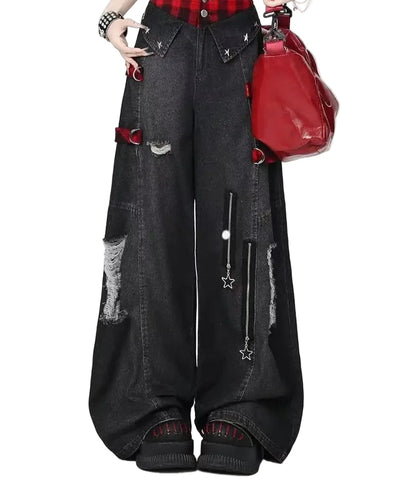 Person wearing black distressed jeans with red plaid shirt and red bag on white background