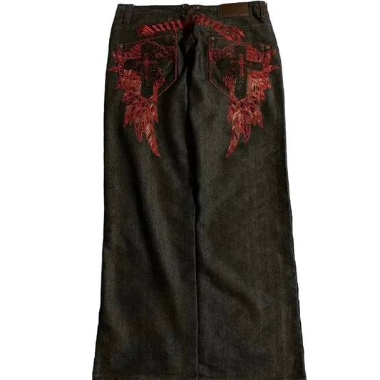 Dark green pants with red embroidered designs on a black background