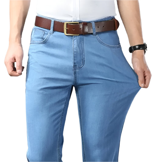 Person wearing blue jeans with a brown belt on a gray background