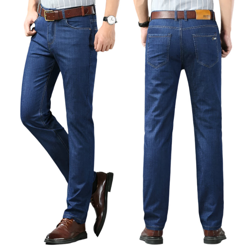 Blue jeans worn by a person on a gray background