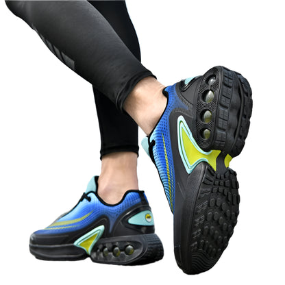 Person wearing blue and black athletic shoes with yellow accents on a blurred outdoor background
