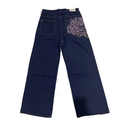 Navy blue jeans with decorative pocket on a white background