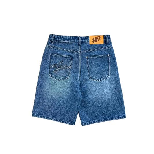 Blue denim shorts on a gray concrete surface