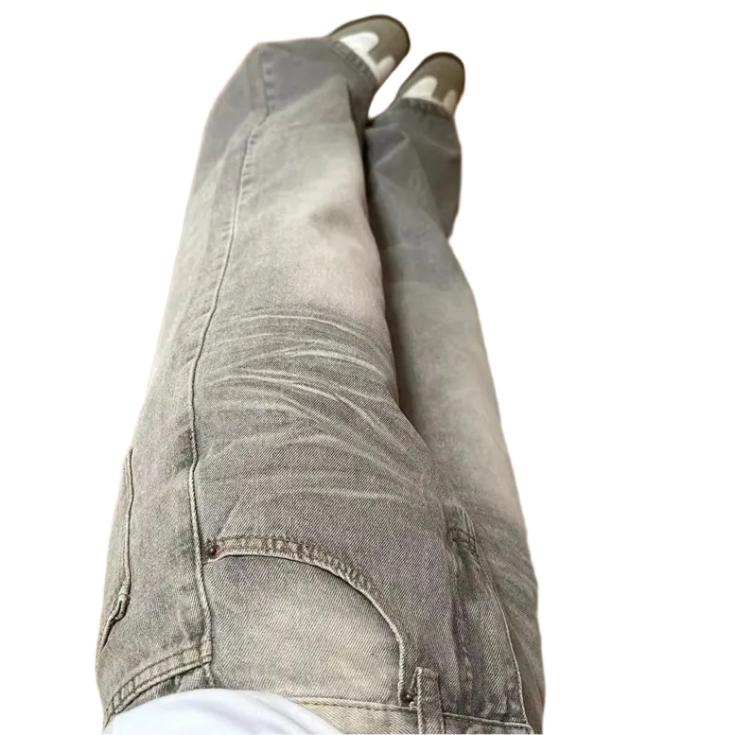 Gray jeans being worn on a wooden floor