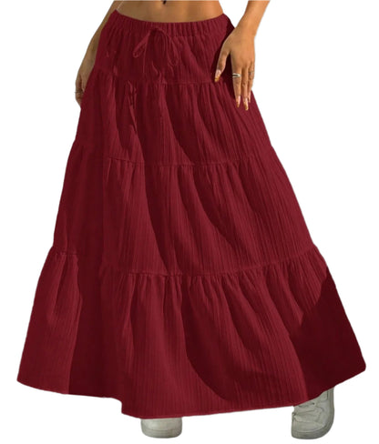 Red tiered skirt worn by a person on a plain background