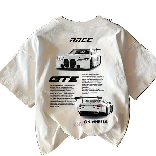 White t-shirt with car graphics and text on a wooden surface