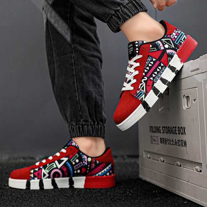 Person wearing red and black patterned sneakers with black pants, standing next to a storage box.