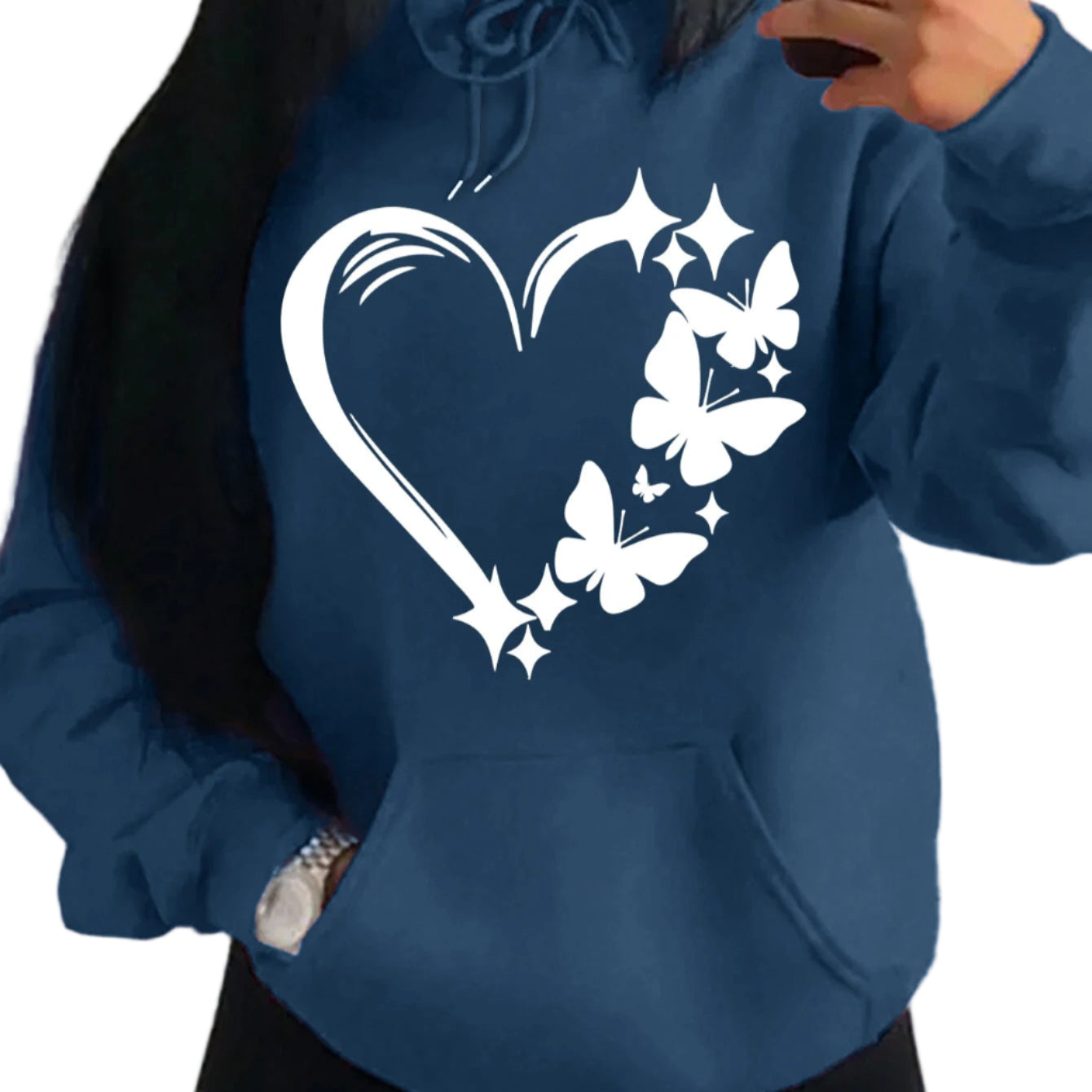 Person wearing a blue hoodie with a heart and butterfly design.