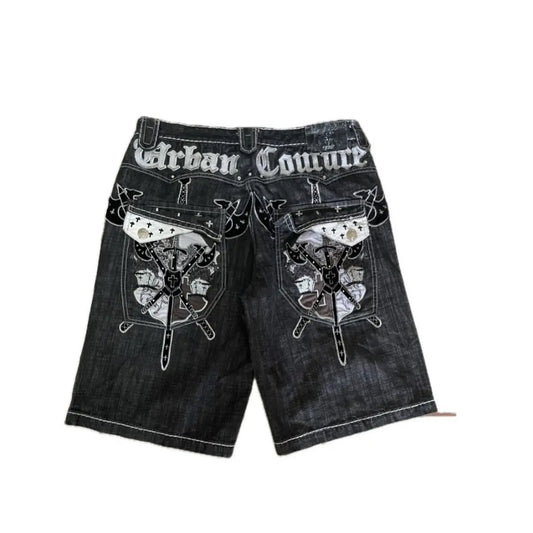 Denim shorts with decorative patterns and 'Urban Couture' branding on a white background