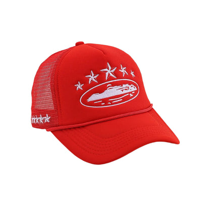 Red cap with white embroidered design on a beige background