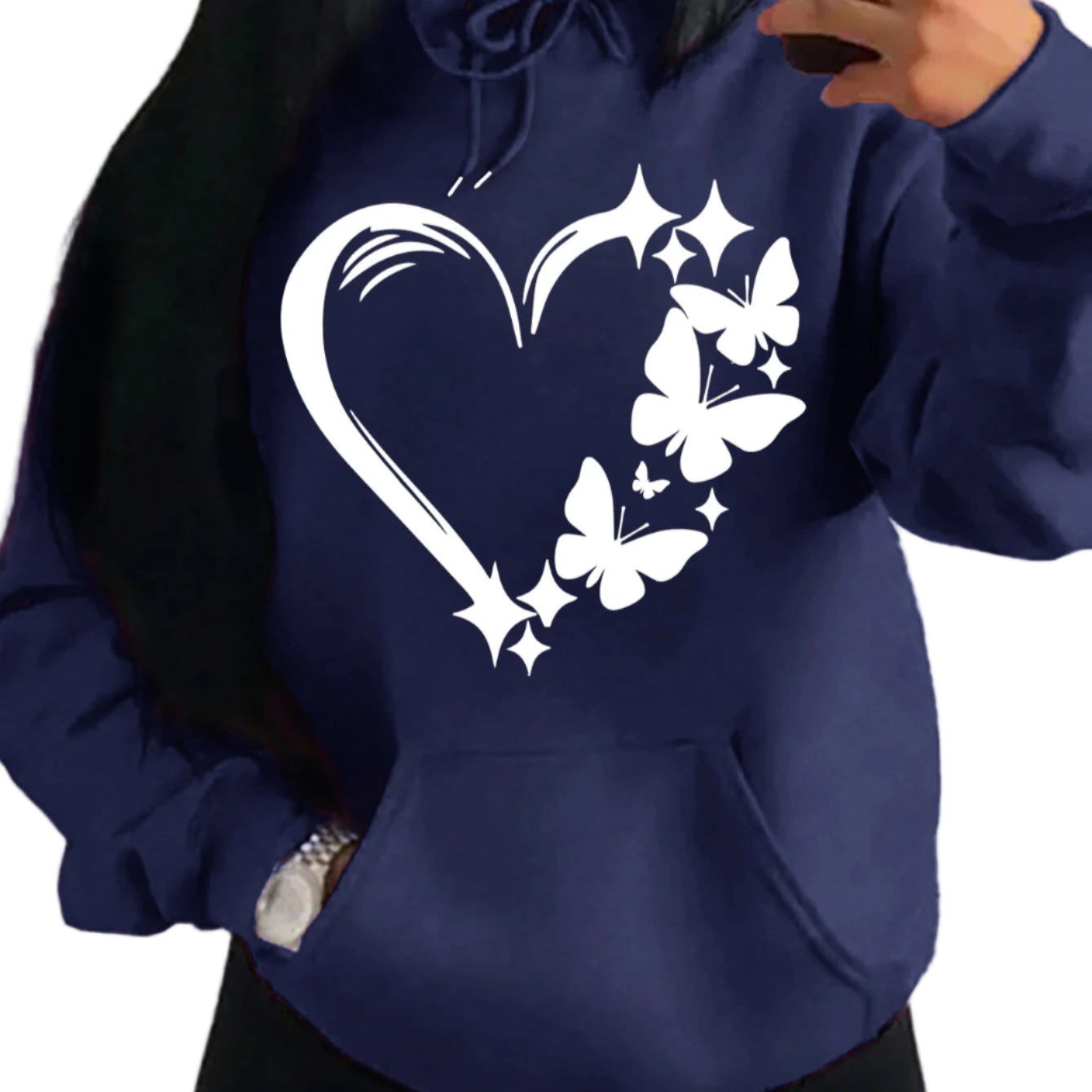 Navy blue hoodie with white heart and butterfly design worn by a person.