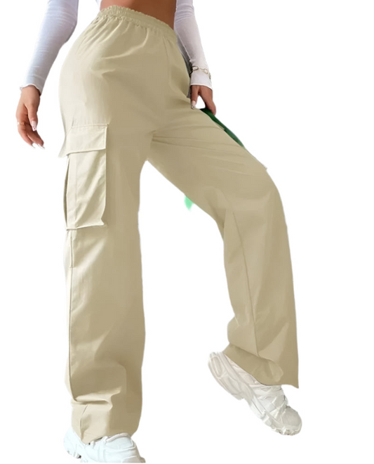 Person wearing beige cargo pants and white sneakers against a gray wall.